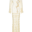 Andreeva handmade butter yellow vanilla crochet maxi dress displayed on a hanger with intricate crochet details.