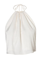 Baobab Lorena top in Mascarpone color shown on a model, featuring a stylish sleeveless design and soft fabric for a chic look.