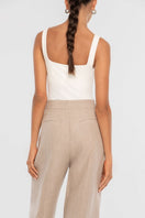 Dāl the Label linen wide-leg pants in a relaxed fit, featuring a high waist and flowing fabric, displayed on a hanger.