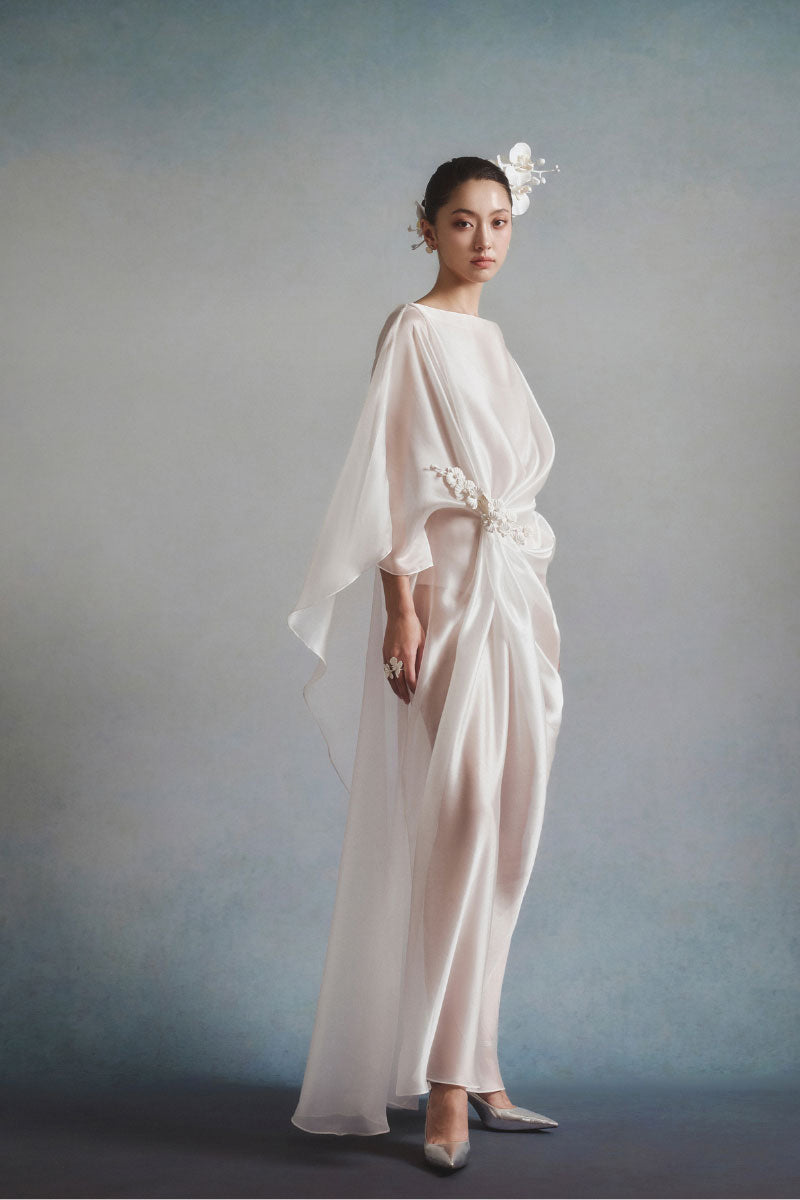 White Plan Aurelia draped maxi dress featuring flowing fabric and elegant design, perfect for stylish occasions.