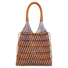 Blue and tan leather and suede shoulder bag by Adriana Castro featuring a stylish design and adjustable strap.