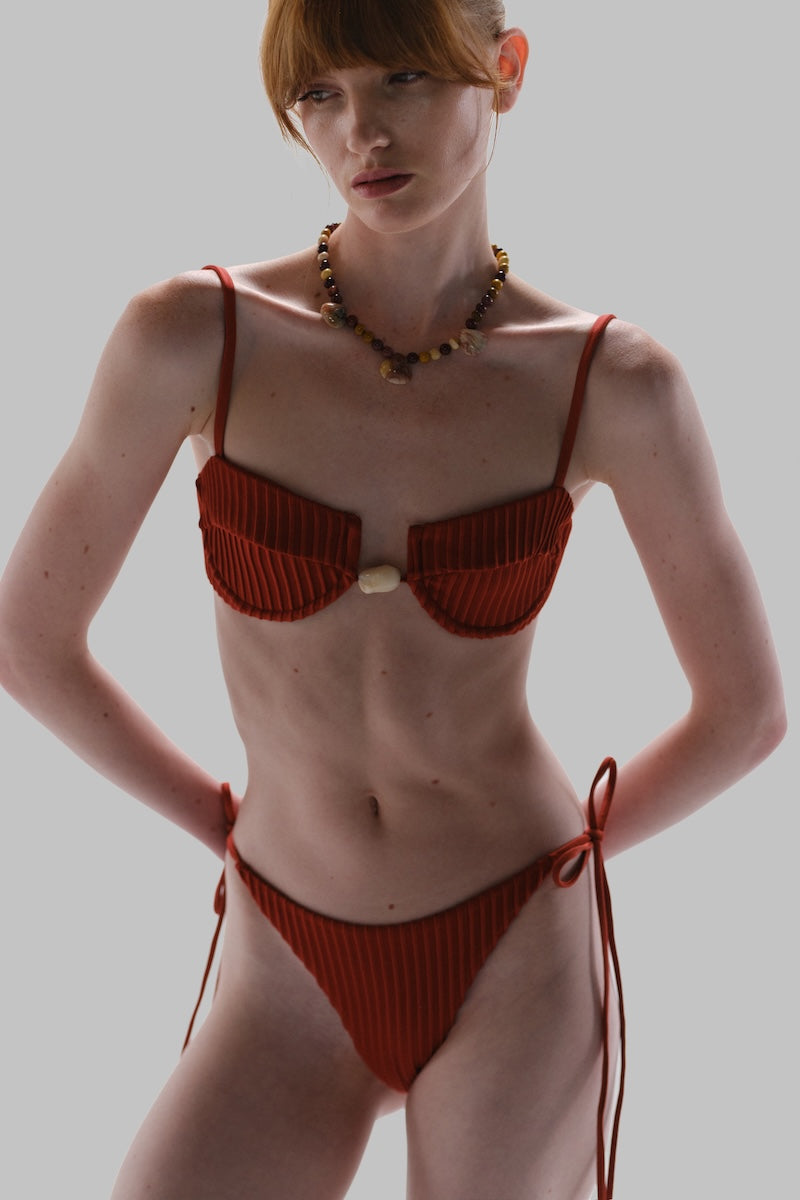 Baobab Roma bikini bottom in vibrant fabric, featuring a stylish cut and seamless design for a comfortable fit.