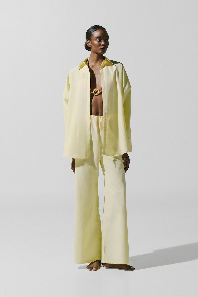 Baobab Wayra shirt in Limone color, lightweight cotton, with a relaxed fit and button-down design, displayed on a hanger.