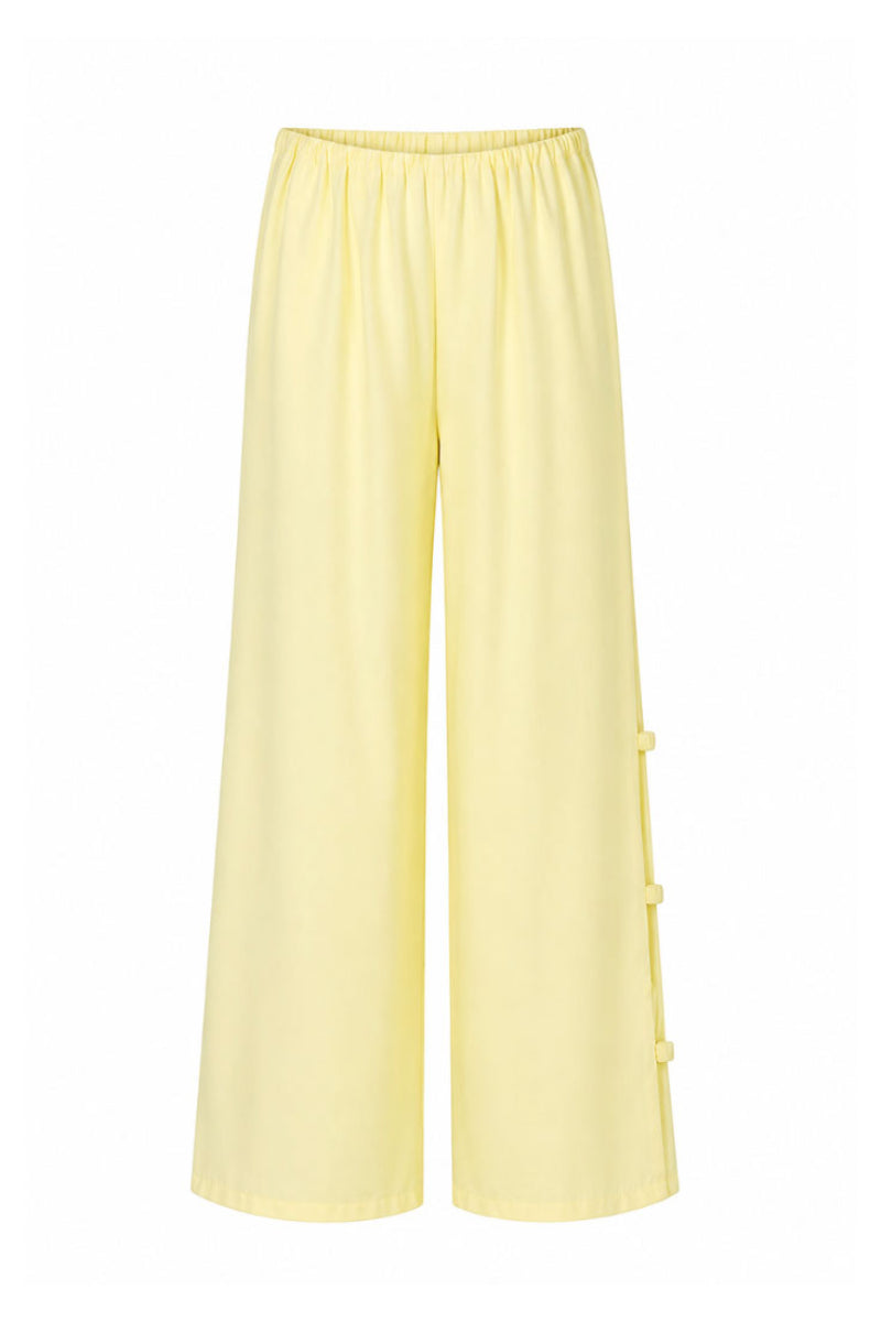 Baobab Wayra pants in Limone color, featuring lightweight fabric and relaxed fit, perfect for casual or outdoor wear.