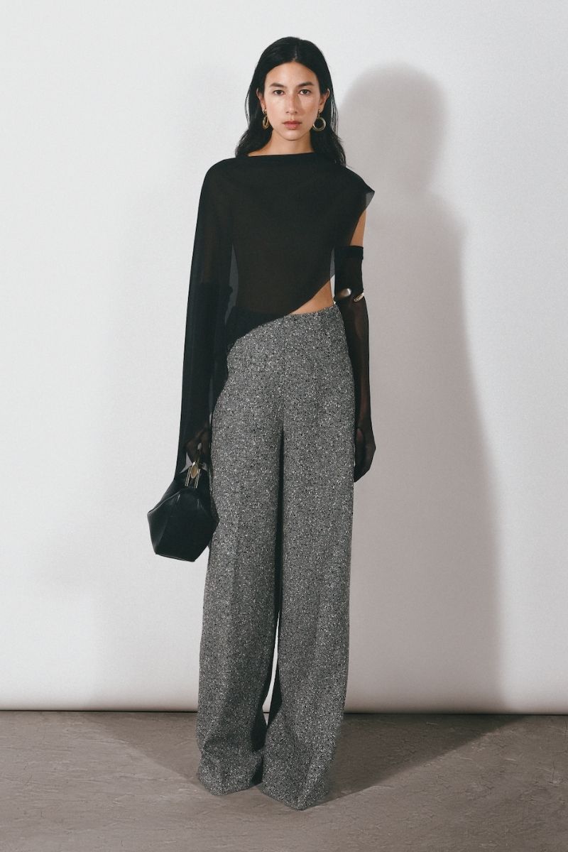 Black asymmetric see-through cape jacket by Leicia, featuring sheer fabric and elegant drape, perfect for stylish layered looks.
