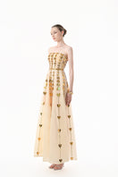 Elegant champagne metallic gown with heart embellishments by Happy Clothing, featuring a flowing design and intricate detailing.