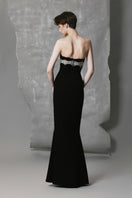 Black straight long gown with intricate beadwork by Phan Huy, featuring a sleek silhouette and detailed embellishments.