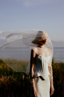 White strapless S-bend corset top by Sudi Etuz, featuring structured design and fitted silhouette, shown on a mannequin.