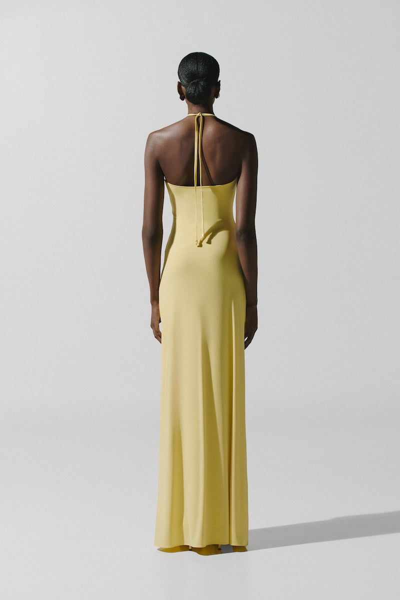 Baobab Romina maxi dress in light yellow, flowing fabric with a relaxed fit, perfect for summer wear.
