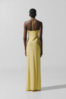 Baobab Romina maxi dress in light yellow, flowing fabric with a relaxed fit, perfect for summer wear.