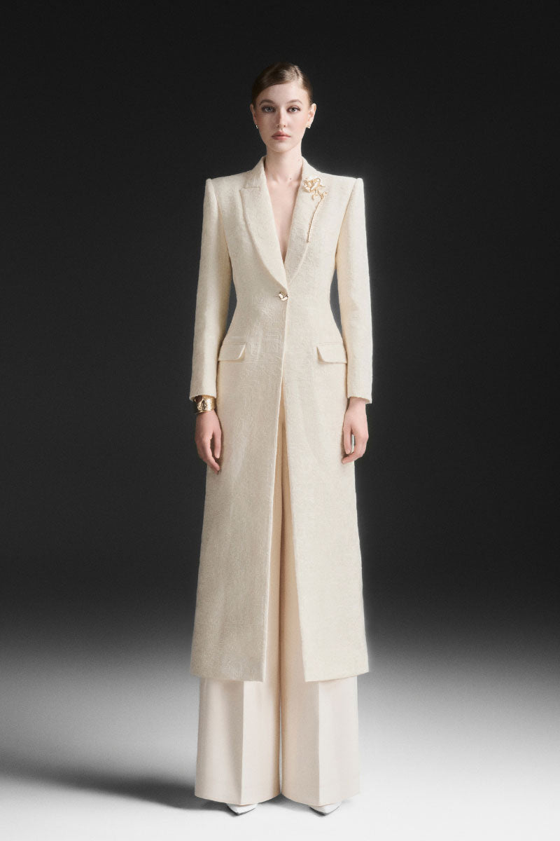 Maison Des Copains ivory cream V-neck trench coat with classic design, shown on a model with belt and double-breasted style.