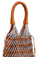 Adriana Castro blue and tan leather and suede shoulder bag with sleek design and adjustable strap.