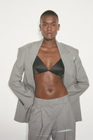 Nué Poppy Bullet Bra shown on a model, featuring smooth cups, adjustable straps, and a feminine, supportive design.