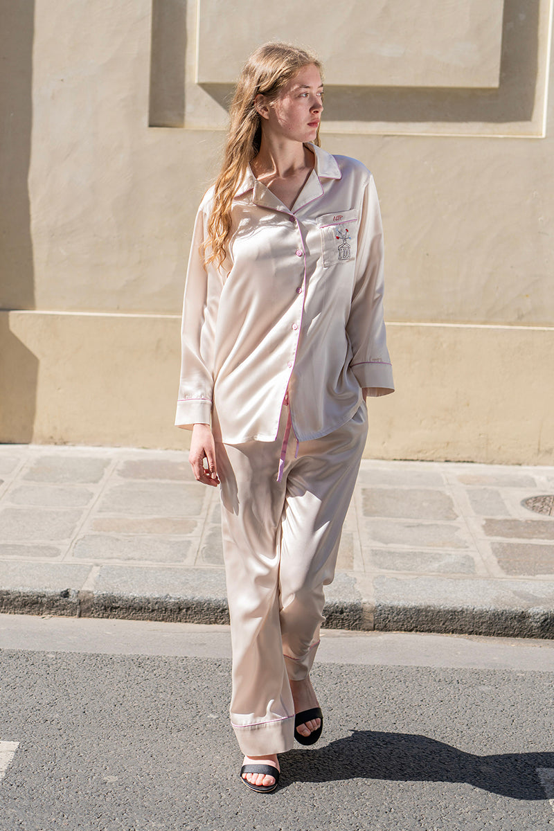 Soft blush pink silk pajama set by Not Just Pajama featuring long sleeves and a relaxed fit, perfect for comfortable sleepwear.