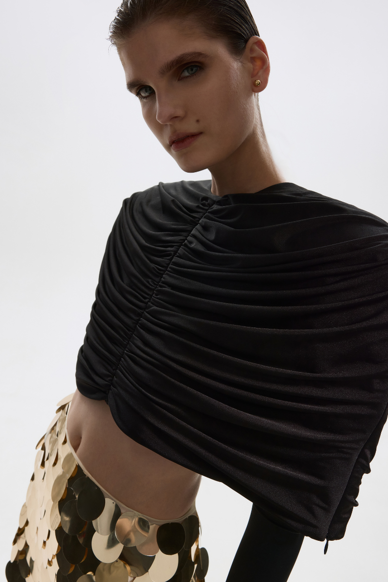 Black stretch cape jacket by Balykina, featuring a flowy design and elegant drape, ideal for stylish outerwear.