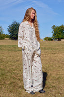 Unisex brown print twill pajamas set featuring a long-sleeve top and matching pants, comfortable sleepwear from Not Just Pajama.
