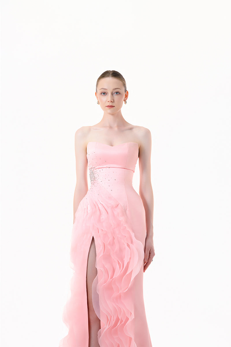 Blush pink strapless ruffle slit gown by Happy Clothing, featuring a flowing design and elegant ruffle details.