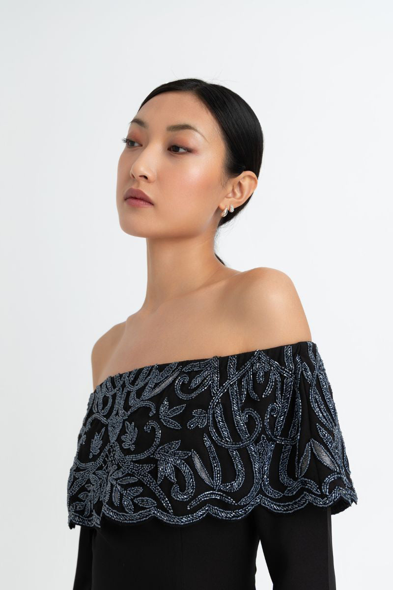 Elegant black gown by Raishma with intricate detailing, flowing fabric, and a sophisticated silhouette perfect for formal occasions.