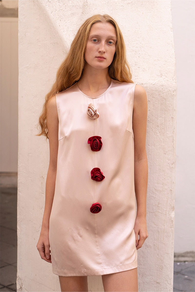 Pink Bloom Silk sleeveless mini dress by Not Just Pajama, shown hanging with flowy fabric and elegant sleeveless design.