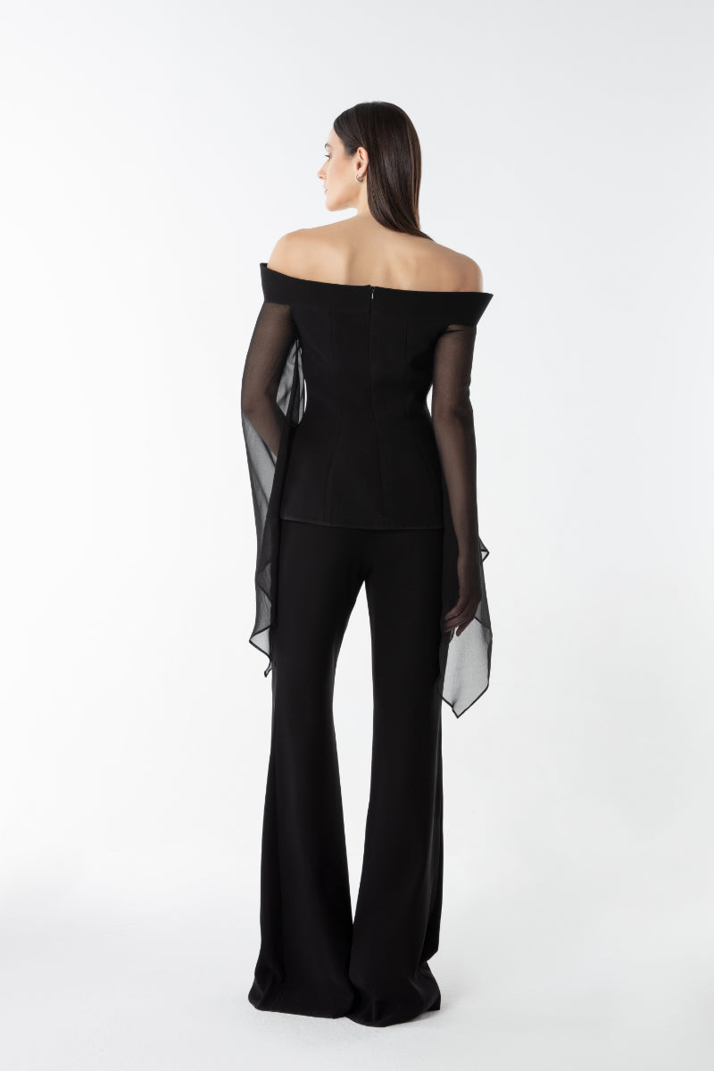 Lili Blanc flow flare trousers with wide legs and high waist, shown in a relaxed fit on a model.