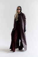 ZUT Palermo leather coat displayed on a hanger, showcasing its stylish design and rich brown leather material.