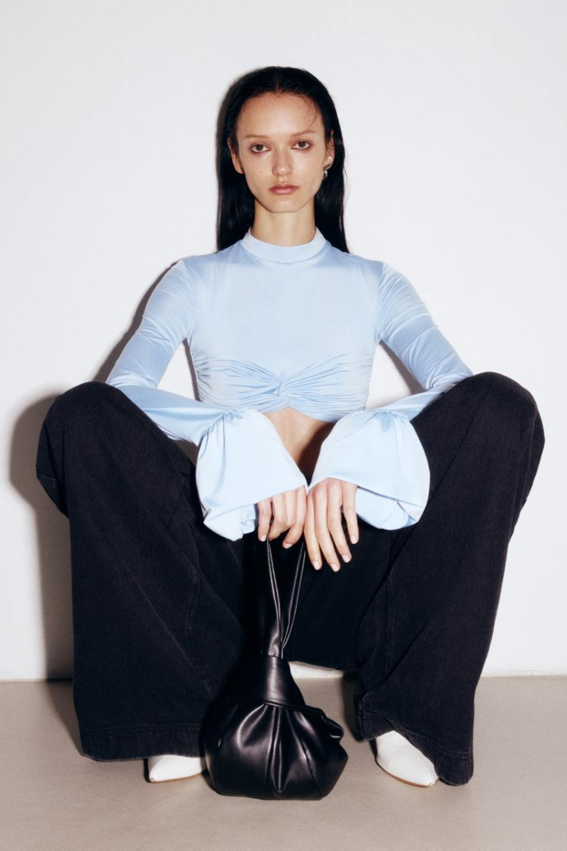Black wide-leg jeans by ELENAREVA, showing the relaxed fit and high-waisted design on a model.