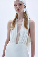 Nazlı Ceren INES long white jersey maxi dress displayed on a hanger, showcasing its elegant, flowing fabric and simple design.