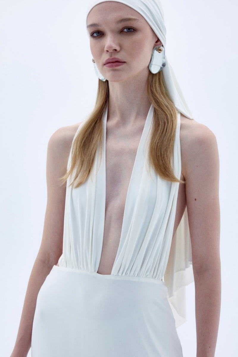Nazlı Ceren INES long white jersey maxi dress displayed on a hanger, showcasing its elegant, flowing fabric and simple design.