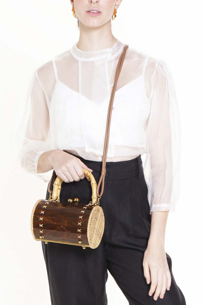 Waiwai Rio Alix Bambu Turtle Top Handle Bag in natural bamboo with turtle design, featuring a woven texture and rounded handles.