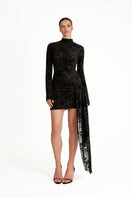 Black KALESY mini dress by Khanum's displayed on a hanger, showcasing its sleek, fitted design and stylish short length.