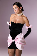 Nur Karaata velvet society mini dress displayed on a hanger, showcasing its luxurious fabric and stylish design.