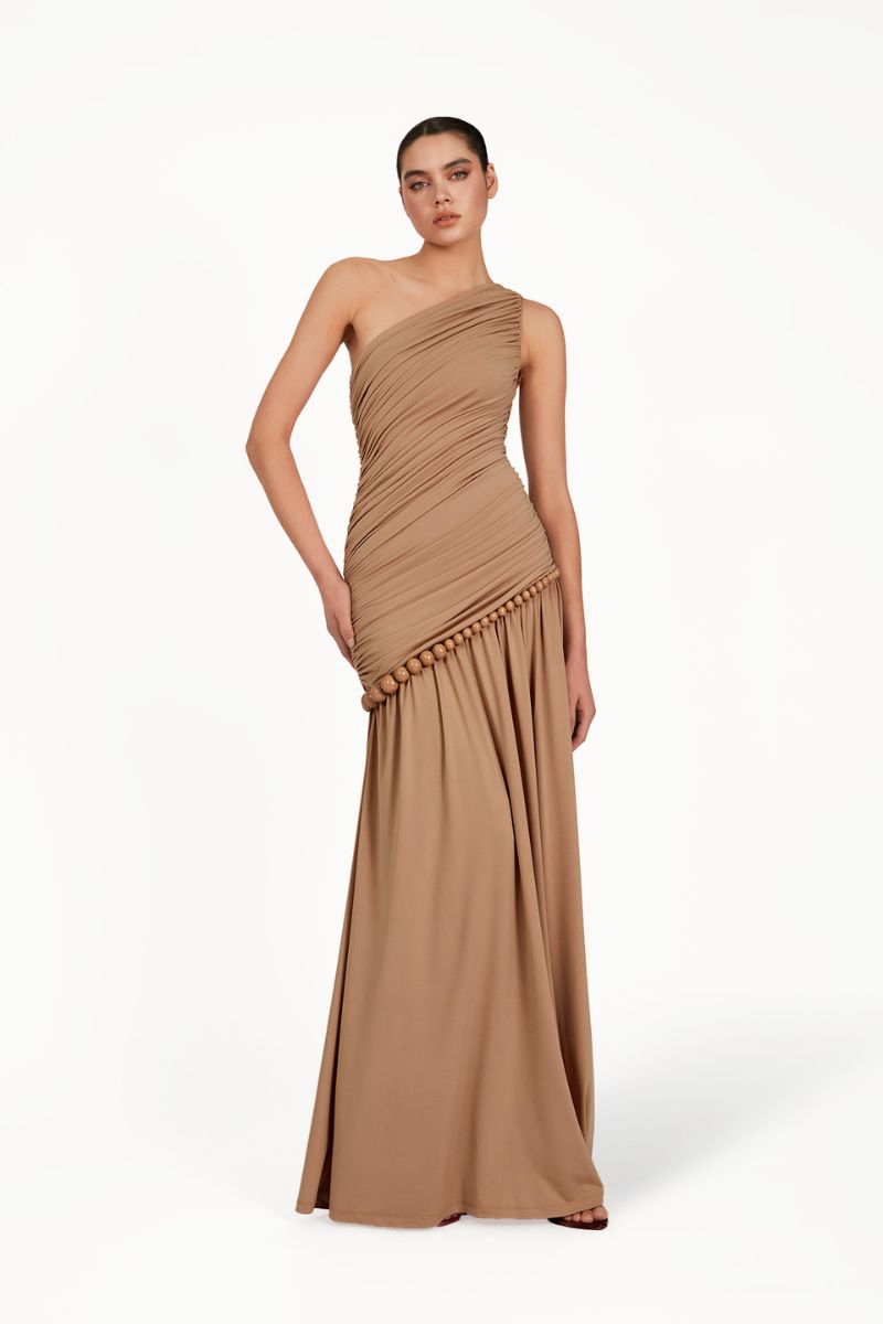 Khanum's Kasba tan maxi dress with flowing fabric and elegant design, perfect for casual or semi-formal occasions.