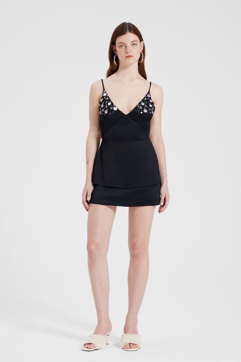 Black embroidered V-neck top by Nara Niro, featuring intricate embroidery and a stylish V-neck design, worn by a model.