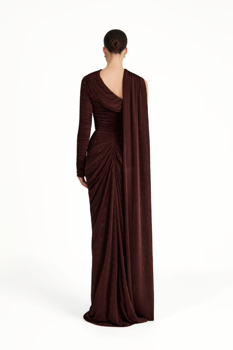 KEMMIYE brown maxi dress by Khanum's, flowing fabric and elegant design, displayed on a hanger against a neutral background.