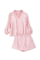 MANITO Sophia ruffle trim pink loungewear set featuring a blouse with ruffled details and matching shorts.