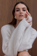 Undress Alexa Cream Mini Sweater Dress shown on model, featuring a cozy cream knit mini dress with long sleeves and a fitted silhouette.