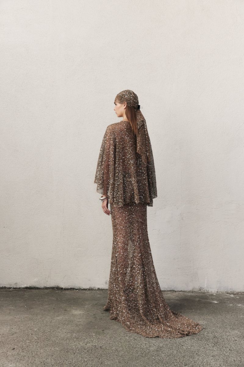 Nazlı Ceren crochet maxi skirt in antique bronze, featuring intricate crochet patterns and flowing fabric.