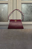 Vikele Studio Burgundy Stephanie Bag, a stylish top handle bag with a sleek design and elegant finish.