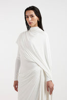 Deme By Gabriella Nadia white draped gown, elegant floor-length dress with flowing fabric and sophisticated design.