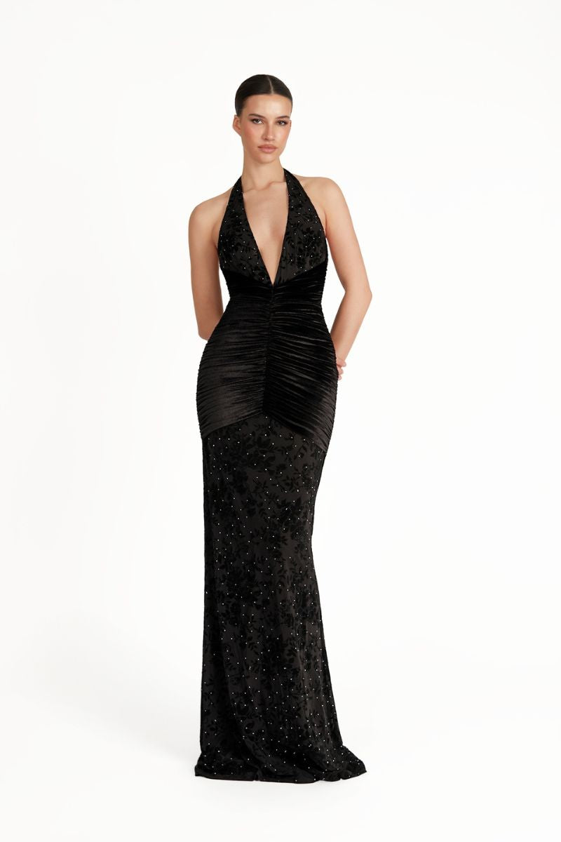 Khanum's Kaylin black maxi dress displayed on a model, featuring a flowing silhouette and elegant design.