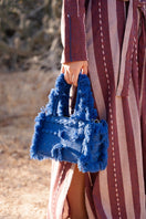 Navy blue Bani mini Poka top handle bag with a sleek design and structured shape, featuring a top handle and compact size.