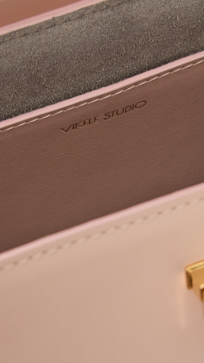 VIKELE STUDIO Stephanie pink top handle bag with sleek design and smooth finish, featuring a stylish, compact silhouette.