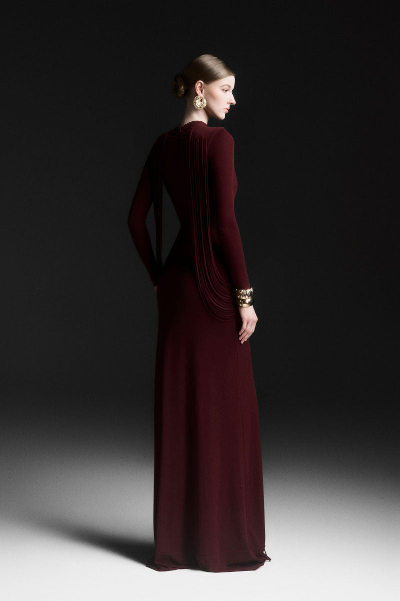 Red Maison Des Copains Avielle draped floor-length maxi dress displayed on a mannequin with flowing fabric and elegant design.