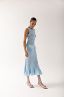 Andreeva knit maxi dress with feather details, flowing design, and long sleeves, perfect for elegant casual or evening wear.