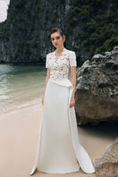 White satin taffeta gown by Lune De Soie, featuring elegant flowing fabric and a sophisticated design for formal occasions.