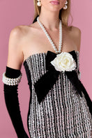 Nur Karaata Vivienne Rose Mini Dress displayed on a model, showcasing its floral pattern and stylish fit.