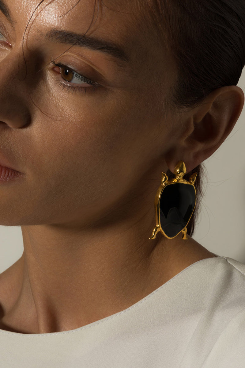 Natia x Lako turtle earrings featuring small, detailed turtle charm dangles on silver hooks suitable for everyday wear.