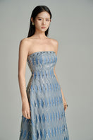 Blue strapless gown by HAPPY CLOTHING featuring a stone fabric and matching scarf, styled for elegant occasions.