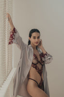 Entos OOLOG burgundy bodysuit with long sleeves and fitted design, shown on a neutral background.