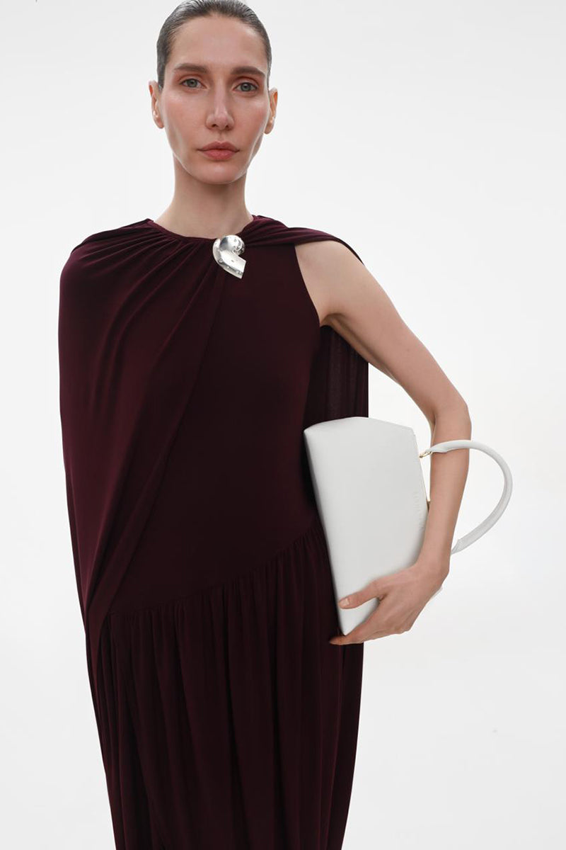 Elegant burgundy jersey midi dress with attached cape by ELENAREVA, featuring a flowing silhouette and stylish design.
